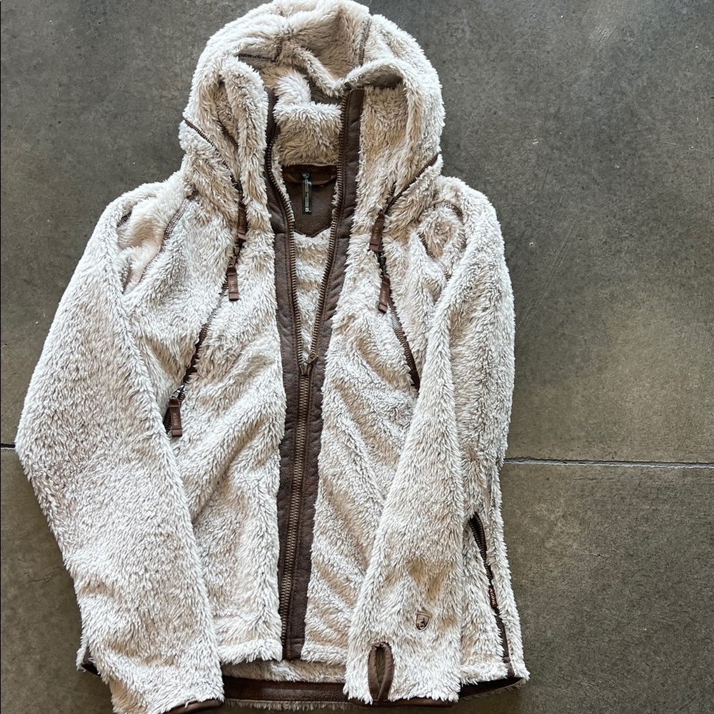 Kuhl Cozy cream with brown trim. Good can be zipped away. Size small